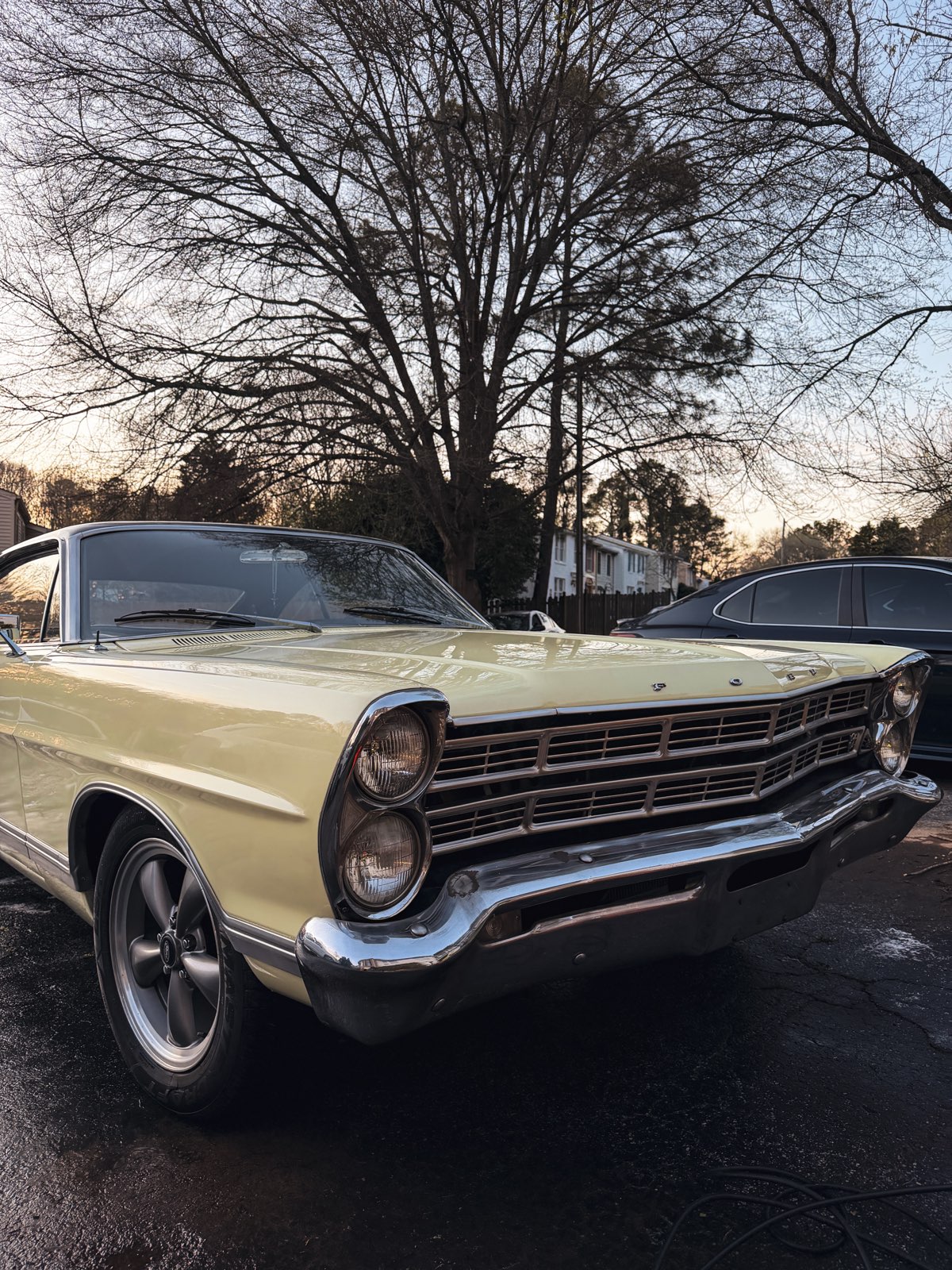 Classic yellow Ford Galaxie exterior, golden hour